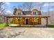 Charming stone home featuring dormer windows and a covered porch with exposed wood rafters at 6150 Red Day Rd, Martinsville, IN 46151