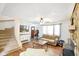 Cozy living room with wood floors, stone accent wall, stairs, and a comfortable seating area with lots of light at 6150 Red Day Rd, Martinsville, IN 46151