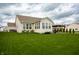 Expansive backyard featuring a lush green lawn, a patio area with pergola, and surrounding trees at 6717 Marble Arch Way, Indianapolis, IN 46259