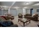 Spacious basement living area with multiple couches and chairs providing ample seating at 6717 Marble Arch Way, Indianapolis, IN 46259