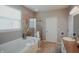 The bathroom offers tile floors, neutral paint, lots of light, shower and separate tub at 6717 Marble Arch Way, Indianapolis, IN 46259