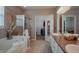 This full bathroom includes a vanity with double sinks, tiled shower, and a large tub with tile surround at 6717 Marble Arch Way, Indianapolis, IN 46259