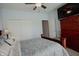 Bedroom featuring a wooden dresser, carpet, a fan, and a bed with a floral comforter at 6717 Marble Arch Way, Indianapolis, IN 46259
