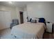 Bedroom with a comfortable full size bed with a plush duvet and decorative pillows, side tables, and a relaxing chair at 6717 Marble Arch Way, Indianapolis, IN 46259
