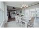 Open-concept dining room with modern chandelier and backyard access at 6717 Marble Arch Way, Indianapolis, IN 46259