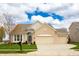 Charming ranch home featuring manicured lawn, two-car garage, and inviting front entrance at 6717 Marble Arch Way, Indianapolis, IN 46259