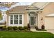 Beautiful front entrance with manicured bushes and flower pots at 6717 Marble Arch Way, Indianapolis, IN 46259