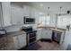 Updated kitchen with white cabinets, granite countertops, and stainless steel appliances at 6717 Marble Arch Way, Indianapolis, IN 46259