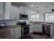 Modern kitchen with stainless steel appliances and granite countertops at 6717 Marble Arch Way, Indianapolis, IN 46259
