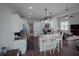 Open-concept kitchen with white cabinetry, granite counters, and bar seating at 6717 Marble Arch Way, Indianapolis, IN 46259