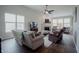 Bright living room featuring large windows, fireplace, and a ceiling fan at 6717 Marble Arch Way, Indianapolis, IN 46259