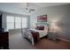 The main bedroom features a vaulted ceiling, ceiling fan, neutral paint and an elegant, wrought-iron bed frame at 6717 Marble Arch Way, Indianapolis, IN 46259