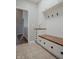 This custom mudroom includes hooks, storage, drawers, upper cabinets, and seating at 6717 Marble Arch Way, Indianapolis, IN 46259