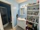 The light blue bathroom showcases a walk-in shower and a white vanity with ample storage at 676 Sunblest Blvd, Fishers, IN 46038