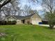 Inviting single-story home featuring a double garage, manicured lawn, and simple, clean landscaping at 676 Sunblest Blvd, Fishers, IN 46038
