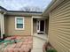 Inviting home exterior featuring a red brick walkway and a welcoming front entrance with tan siding and a black door at 676 Sunblest Blvd, Fishers, IN 46038