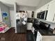 Modern kitchen with stainless steel appliances, white cabinets, and black countertops, providing a sleek and functional space at 676 Sunblest Blvd, Fishers, IN 46038