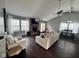 The light-filled living room features hardwood floors, a fireplace, and an adjacent dining area, ideal for entertaining at 676 Sunblest Blvd, Fishers, IN 46038