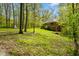 A spacious backyard with mature trees offering privacy, accompanied by a shed and swing set, perfect for outdoor enjoyment at 6780 E Woodland Ct, Mooresville, IN 46158