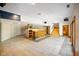 Finished basement with tile flooring, a wet bar, and stone-accented staircase at 6780 E Woodland Ct, Mooresville, IN 46158