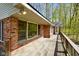 Exterior wooden deck with brick features, complemented by natural light, providing an inviting space to relax at 6780 E Woodland Ct, Mooresville, IN 46158