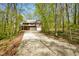 Expansive driveway leading to a two-story brick home with a balcony and attached garage at 6780 E Woodland Ct, Mooresville, IN 46158