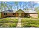 Charming brick ranch-style home with a well-maintained front yard and mature trees at 6780 E Woodland Ct, Mooresville, IN 46158