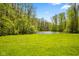 A peaceful pond surrounded by lush greenery, creating a tranquil setting at 6780 E Woodland Ct, Mooresville, IN 46158