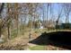 Backyard view showcasing yard space, mature trees, and a glimpse of the main house at 701 E Main St, Westfield, IN 46074