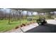 Lush backyard with well-manicured landscaping and a vintage tractor at 701 E Main St, Westfield, IN 46074
