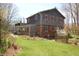 Beautiful backyard featuring landscaping and shingle-style home with brick foundation and lattice porch at 701 E Main St, Westfield, IN 46074