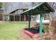 Outdoor seating area overlooking the backyard includes a bench, covered structure and manicured lawn at 701 E Main St, Westfield, IN 46074
