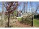 The backyard landscaping features a red-leafed tree and a white blossoming shrub by a wooden fence at 701 E Main St, Westfield, IN 46074
