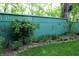 Landscaped yard features a green fence decorated with metal art, creating a charming and private outdoor space at 701 E Main St, Westfield, IN 46074