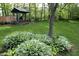 Gazebo nestled among lush greenery and shade trees, perfect for relaxing and enjoying the outdoors at 701 E Main St, Westfield, IN 46074