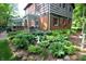 Lush backyard garden with vibrant plants, landscaping, and a charming brick home in the background at 701 E Main St, Westfield, IN 46074