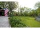 Expansive lawn with mature trees, featuring a charming gazebo and garden beds, perfect for outdoor enjoyment at 701 E Main St, Westfield, IN 46074