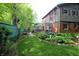 Scenic view of a well-maintained backyard with lush greenery, walkway, and a charming two-story home at 701 E Main St, Westfield, IN 46074