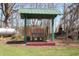 Seating structure with a bench and overhead covering sitting in a wooded backyard at 701 E Main St, Westfield, IN 46074