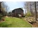 Landscaped backyard of shingle-style home offers a bench seat to enjoy the outdoor view at 701 E Main St, Westfield, IN 46074