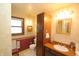 Classic bathroom with tiled floor, featuring built-in cabinet and framed mirror at 701 E Main St, Westfield, IN 46074