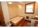 Bright bathroom showcasing a jetted tub with wood accents and floral wallpaper at 701 E Main St, Westfield, IN 46074