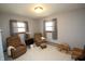 Relaxing bedroom with soft, natural light, comfortable armchairs, and neutral color palette at 701 E Main St, Westfield, IN 46074