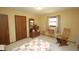Well-lit bedroom with matching wood furniture and view of bright window at 701 E Main St, Westfield, IN 46074