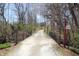 Quaint bridge view with a charming country home nestled amongst trees at 701 E Main St, Westfield, IN 46074