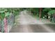 Driveway winding through a wooded area, enhanced by a decorative red metal gate at 701 E Main St, Westfield, IN 46074