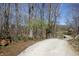 Gravel driveway winds through a wooded property at 701 E Main St, Westfield, IN 46074