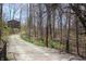 Gravel driveway leading to the house with mature trees at 701 E Main St, Westfield, IN 46074