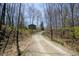Scenic driveway leading to a house with mature trees at 701 E Main St, Westfield, IN 46074