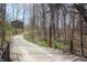 Gravel driveway leading to a secluded home through a wooded area at 701 E Main St, Westfield, IN 46074